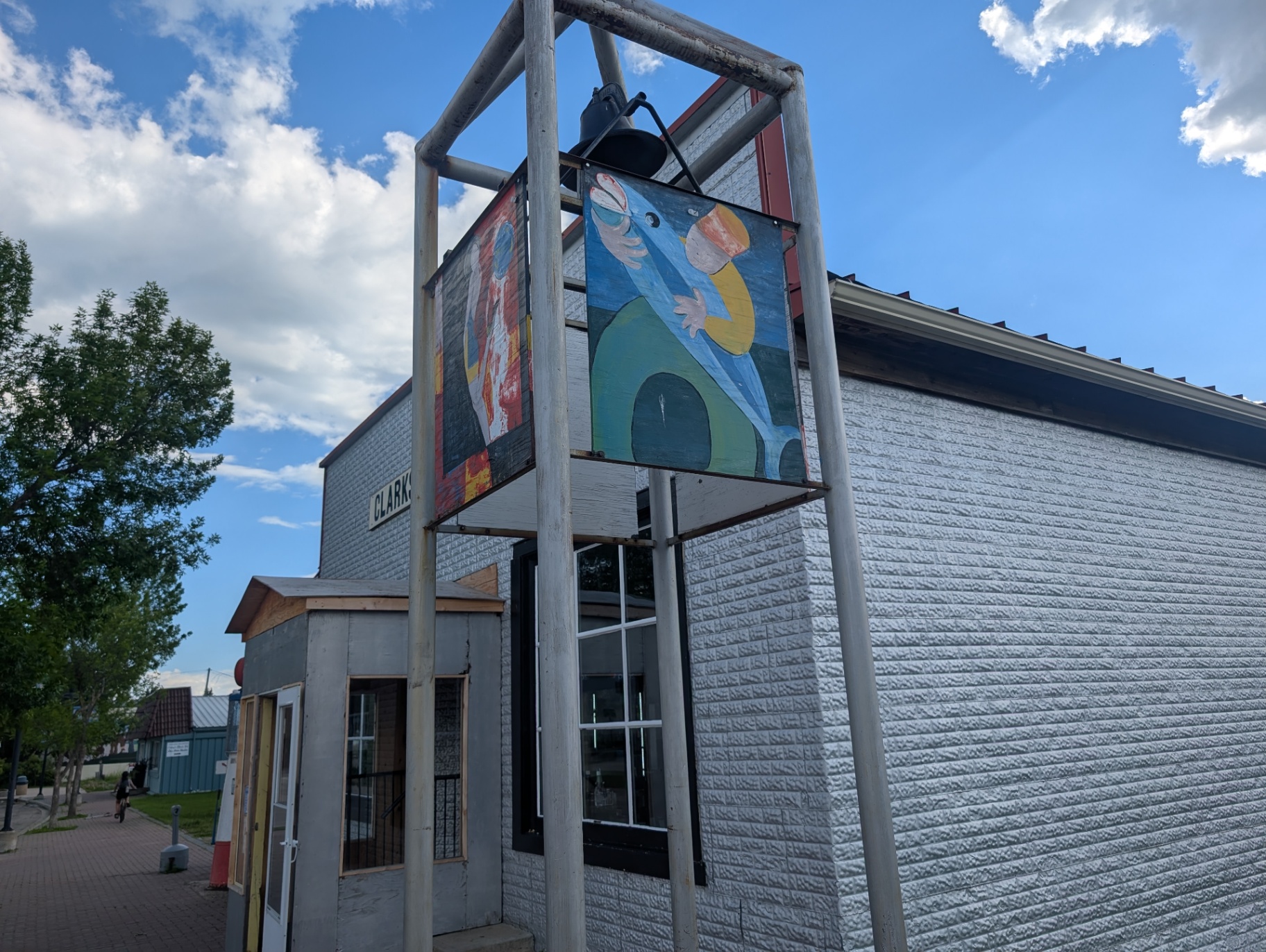Bell tower and painted murals beside Clark's General Store
