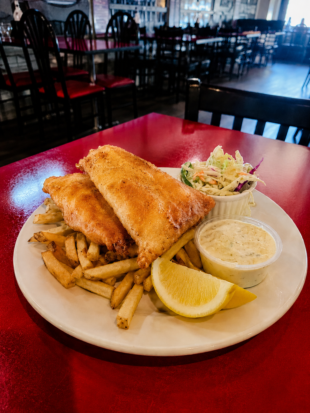 Hand-battered fish and chips with coleslaw and tartar sauce